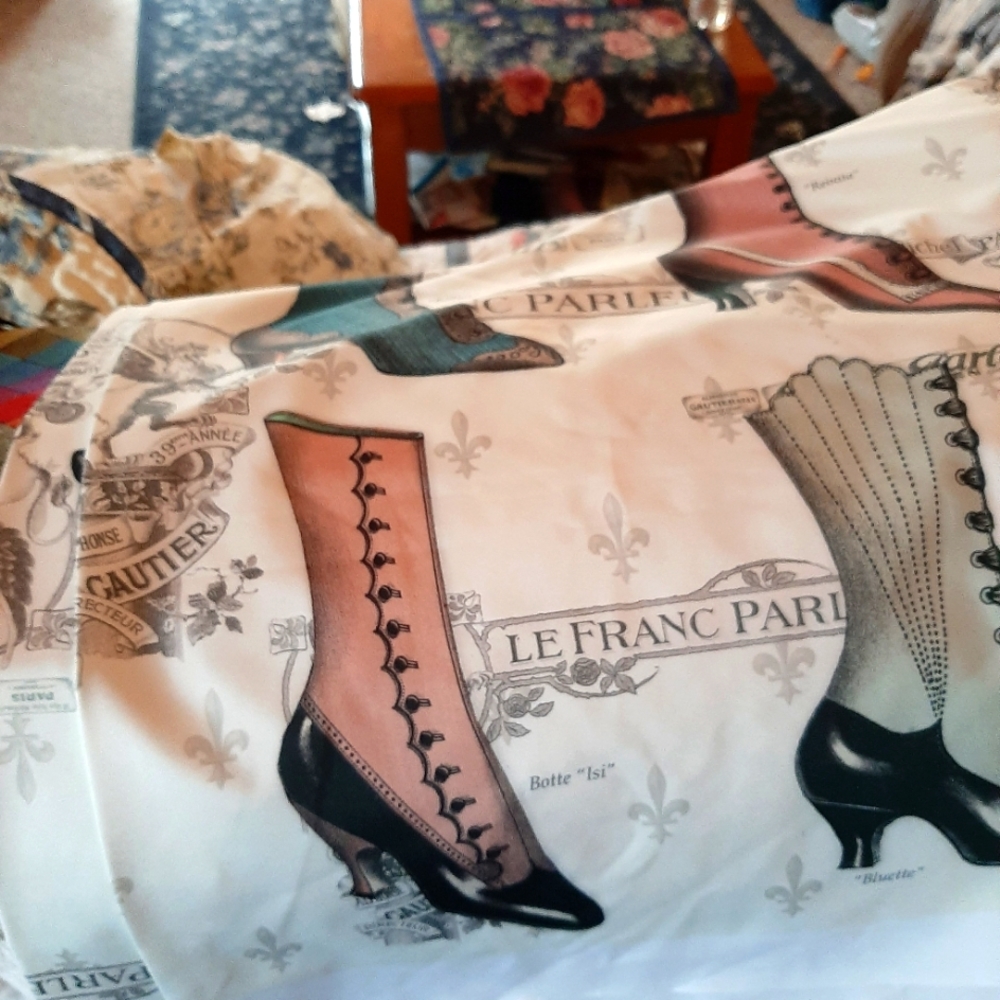 1 yard x 65 inches of polyester, soft fabric with antique shoes on it.